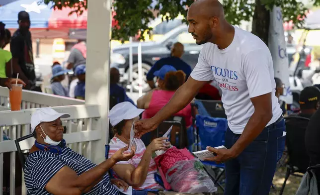 Alabama's new 2nd Congressional District Democratic candidate Shomari Figures greets voters during the Macon County Day Festival in Tuskegee, Ala., on Saturday, Aug 31, 2024. (AP Photo/ Butch Dill)