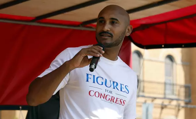 Alabama's new 2nd Congressional District Democratic candidate Shomari Figures speaks during the Macon County Day Festival in Tuskegee, Ala., on Saturday, Aug 31, 2024. (AP Photo/ Butch Dill)