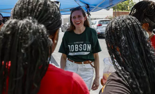 Alabama's new 2nd Congressional District Republican candidate Caroleene Dobson talks with voters during the Macon County Day Festival in Tuskegee, Ala., on Saturday, Aug 31, 2024. (AP Photo/ Butch Dill)