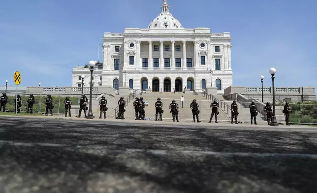 FILE - National Guard and state police guard the Minnesota statehouse Sunday, May 31, 2020, in St. Paul, Minn., following the death of George Floyd, who died after being restrained by Minneapolis police officers on May 25. (AP Photo/Julio Cortez, File)