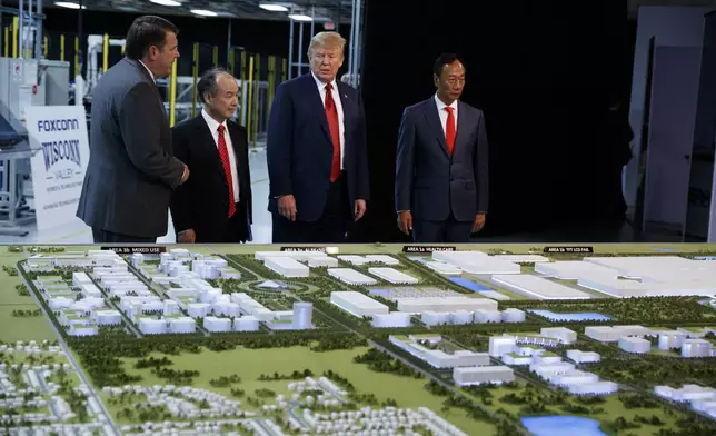 FILE - President Donald Trump tours a Foxconn facility, June 28, 2018, in Mt. Pleasant, Wis. (AP Photo/Evan Vucci, File)