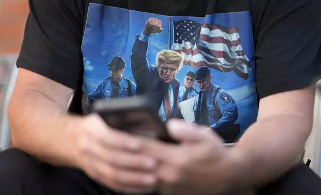 Joseph Wiederien wears a Republican presidential nominee former President Donald Trump t-shirt as he speaks during an interview with The Associated Press, Friday, Sept. 6, 2024, in Des Moines, Iowa. (AP Photo/Charlie Neibergall)