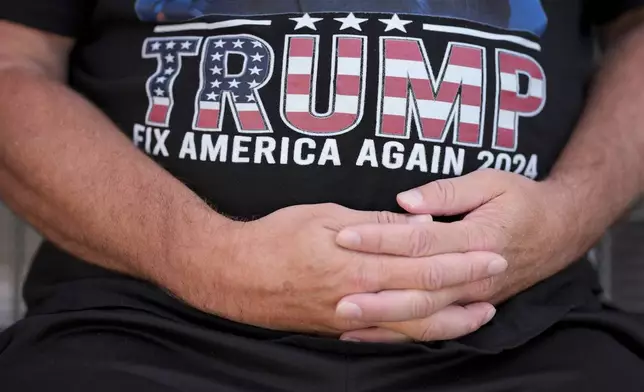 Joseph Wiederien wears a Republican presidential nominee former President Donald Trump t-shirt as he speaks during an interview with The Associated Press, Friday, Sept. 6, 2024, in Des Moines, Iowa. (AP Photo/Charlie Neibergall)