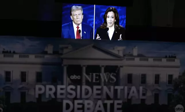 A presidential debate between Republican presidential nominee former President Donald Trump, on screen at left, and Democratic presidential nominee Vice President Kamala Harris, right, is seen from the spin room, Tuesday, Sept. 10, 2024, in Philadelphia. (AP Photo/Matt Slocum)