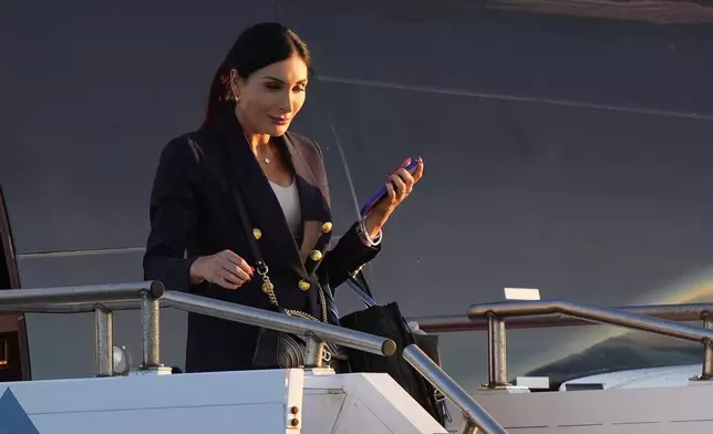 Laura Loomer arrives with Republican presidential nominee former President Donald Trump at Philadelphia International Airport, Tuesday, Sept. 10, 2024, in Philadelphia, for the presidential debate. (AP Photo/Chris Szagola)