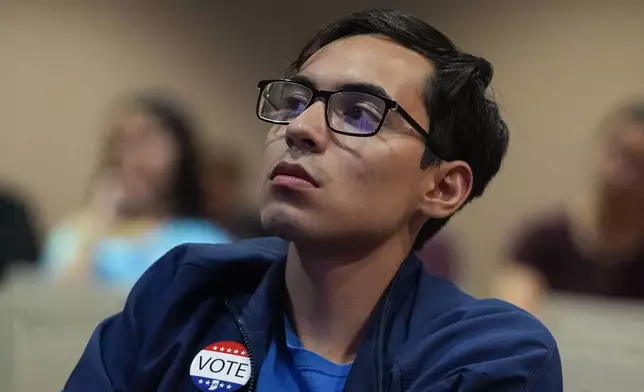 Vincent Cervantes watches the presidential debate between Republican presidential nominee former President Donald Trump and Democratic presidential nominee Vice President Kamala Harris, Tuesday, Sept. 10, 2024, in Muncie, Ind. (AP Photo/Darron Cummings)