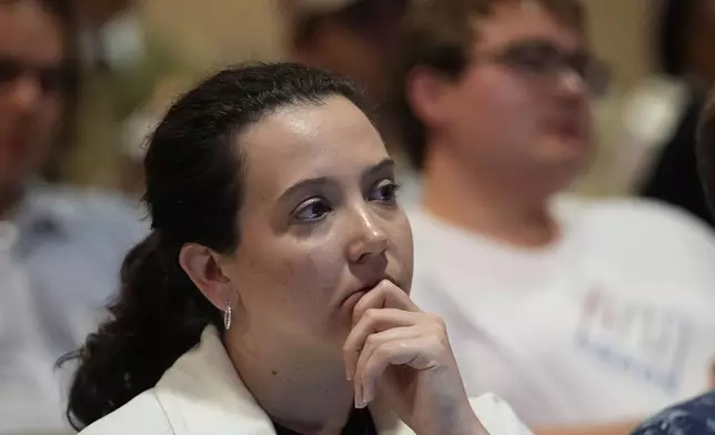 Abigail Denault watches the presidential debate between Republican presidential nominee former President Donald Trump and Democratic presidential nominee Vice President Kamala Harris, Tuesday, Sept. 10, 2024, in Muncie, Ind. (AP Photo/Darron Cummings)