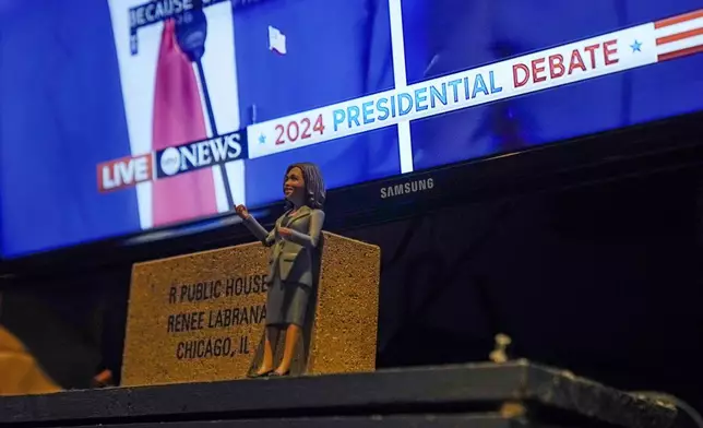 A figure of Democratic presidential nominee Vice President Kamala Harris sits above the bar at R Public House during the presidential debate between Republican presidential nominee former President Donald Trump and Harris, Tuesday, Sept. 10, 2024, in the Rogers Park neighborhood of Chicago. (AP Photo/Erin Hooley)