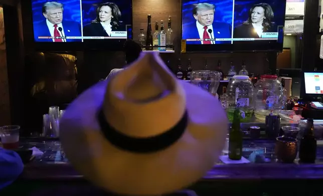 Charles Hudson, 76, from Chicago watches the presidential debate between Republican presidential nominee former President Donald Trump and Democratic presidential nominee Vice President Kamala Harris at the Knotty Luxe Bistro Tuesday, Sept. 10, 2024, in Markham, Ill. (AP Photo/Charles Rex Arbogast)