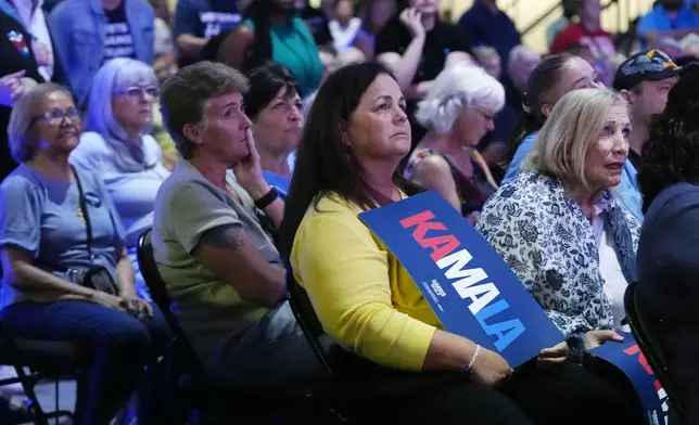 Democratic supporters watch the presidential debate between Democratic presidential nominee Vice President Kamala Harris and Republican presidential nominee former President Donald Trump at a gathering Tuesday, Sept. 10, 2024, in Mesa, Ariz. (AP Photo/Ross D. Franklin)