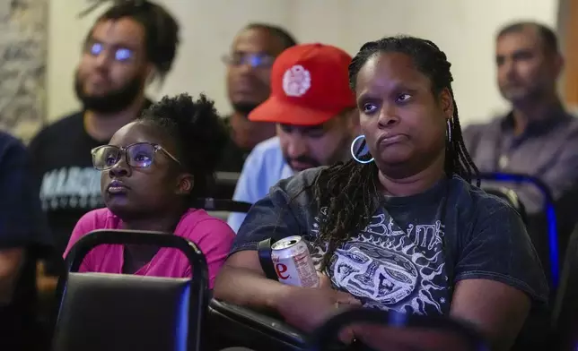 People gather at No Studios to watch the presidential debate between Republican presidential nominee former President Donald Trump and Democratic presidential nominee Vice President Kamala Harris, Tuesday, Sept. 10, 2024, in Milwaukee. (AP Photo/Morry Gash)