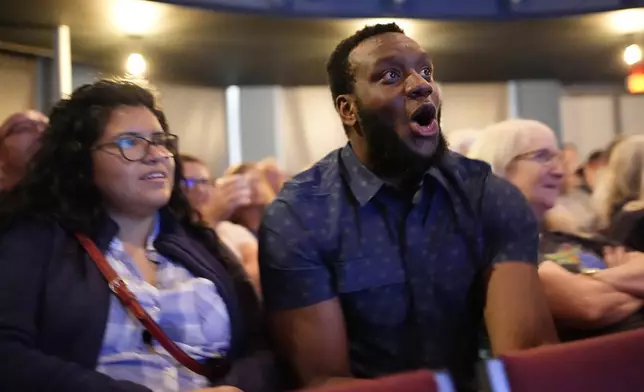 Ikenna Amilo, center, reacts to a comment by Republican presidential nominee former President Donald Trump during a presidential debate with Democratic presidential nominee Vice President Kamala Harris, Tuesday, Sept. 10, 2024, in Portland, Maine. (AP Photo/Robert F. Bukaty)