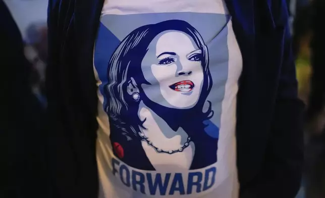 A man wears a tee-shirt with an image of Democratic presidential nominee Vice President Kamala Harris during a watch party organized by the Miami-Dade Democratic Hispanic Caucus to view a presidential debate between Harris and Republican presidential nominee former President Donald Trump, Tuesday, Sept. 10, 2024, at Sports Grill Kendall, in Miami. (AP Photo/Rebecca Blackwell)