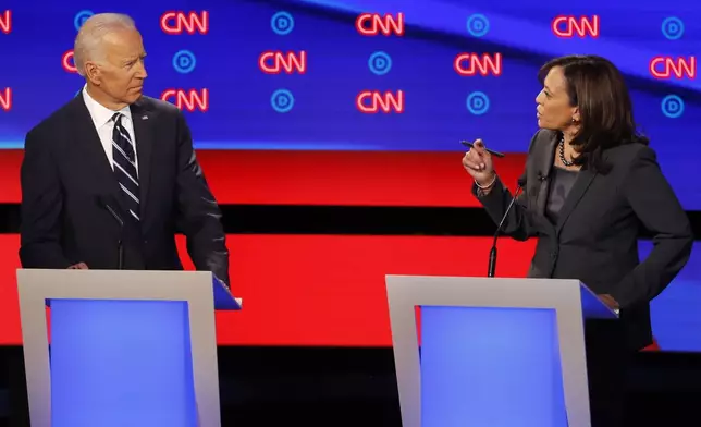 FILE - Former Vice President Joe Biden, left, listens as Sen. Kamala Harris, D-Calif., speaks during a Democratic presidential primary debates, July 31, 2019, in Detroit. (AP Photo/Paul Sancya, File)