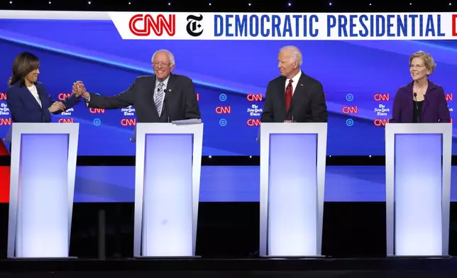 FILE - Democratic presidential candidate Sen. Kamala Harris, D-Calif., from left, Sen. Bernie Sanders, I-Vt., former Vice President Joe Biden and Sen. Elizabeth Warren, D-Mass., participate in a Democratic presidential primary debate, Oct. 15, 2019, in Westerville, Ohio. (AP Photo/John Minchillo, File)