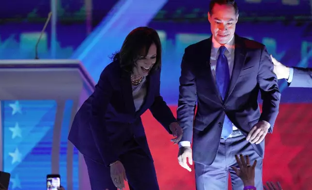 FILE - Democratic presidential candidates Sen. Kamala Harris, D-Calif., left, and former Housing Secretary Julian Castro greet supporters, Sept. 12, 2019, during a Democratic presidential primary debate in Houston. (AP Photo/David J. Phillip, File)