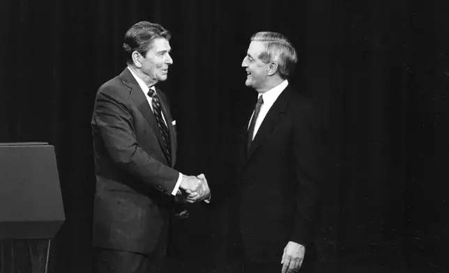 FILE - President Ronald Reagan, left, and his Democratic challenger Walter Mondale, shake hands before debating in Kansas City, Mo., Oct. 22, 1984. (AP Photo/Ron Edmonds, File)