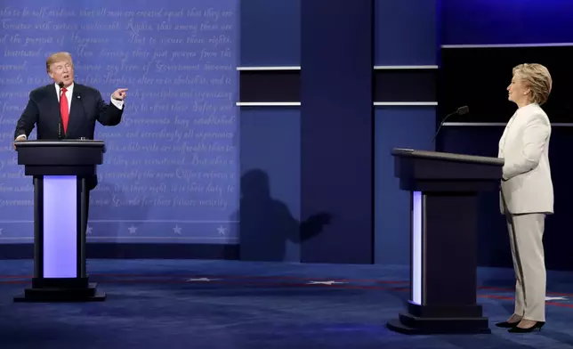 FILE - Democratic presidential nominee Hillary Clinton listens to Republican presidential nominee Donald Trump during the third presidential debate, Oct. 19, 2016. (AP Photo/David Goldman, File)