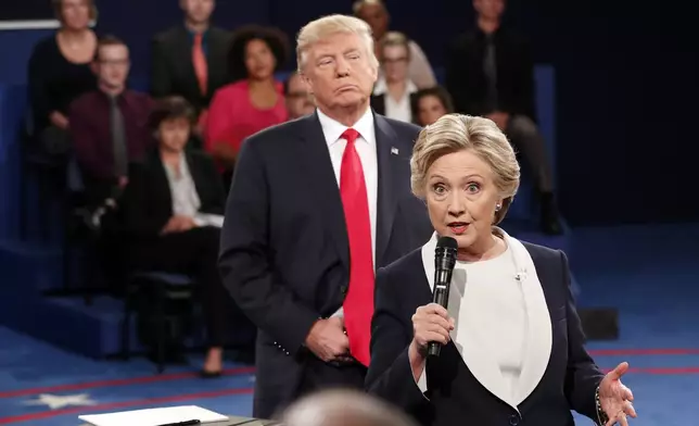 FILE - Democratic presidential nominee Hillary Clinton, right, speaks as Republican presidential nominee Donald Trump listens during the second presidential debate in St. Louis, Oct. 9, 2016. (Rick T. Wilking/Pool via AP, File)