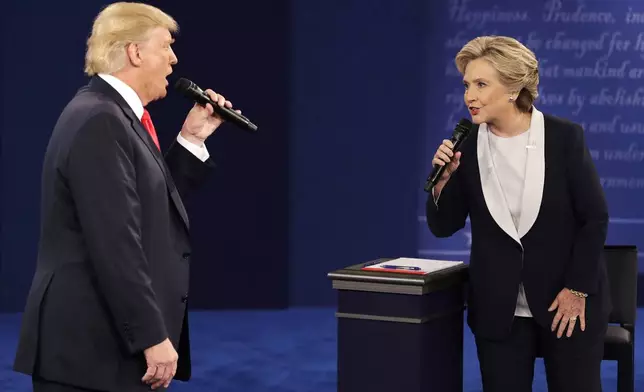 FILE - Republican presidential nominee Donald Trump, left, and Democratic presidential nominee Hillary Clinton speak during the second presidential debate in St. Louis, Oct. 9, 2016. (AP Photo/John Locher, File)