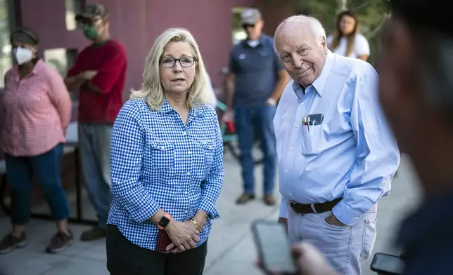 FILE - Rep. Liz Cheney, R-Wyo., arrives, with her father, former Vice President Dick Cheney, to vote at the Teton County Library during the Republican primary election Aug. 16, 2022, in Jackson Hole, Wyo. (Jabin Botsford/The Washington Post via AP, File)