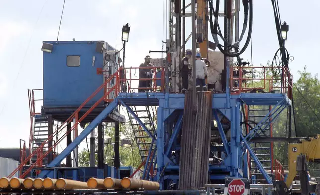 FILE - A crew works on a gas drilling rig at a well site for shale based natural gas in Zelienople, Pa. June 25, 2012. (AP Photo/Keith Srakocic, File)