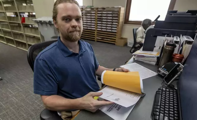 Trey Forrest, Absentee Election Coordinator for the Jefferson County/Birmingham (Ala) Division, prepares absentee ballots for the November election, Tuesday, Sept. 10, 2024, in Birmingham, Ala. (AP Photo/Vasha Hunt)