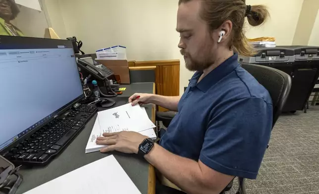 Trey Forrest, Absentee Election Coordinator for the Jefferson County/Birmingham (Ala) Division, prepares absentee ballots for the November election, Tuesday, Sept. 10, 2024, in Birmingham, Ala. (AP Photo/Vasha Hunt)