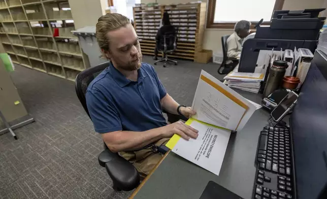 Trey Forrest, Absentee Election Coordinator for the Jefferson County/Birmingham (Ala) Division, prepares absentee ballots for the November election, Tuesday, Sept. 10, 2024, in Birmingham, Ala. (AP Photo/Vasha Hunt)