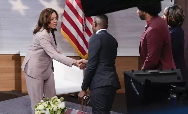 Democratic presidential nominee Vice President Kamala Harris, left, shaking hands with Gerren Keith Gaynor, center, as Eugene Daniels, second from the right, and Tonya Mosley, far right, look on after being interviewed by the National Association of Black Journalists at the WHYY studio in Philadelphia, Tuesday, Sept. 17, 2024. (AP Photo/Jacquelyn Martin)