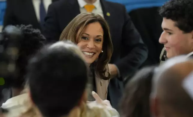 Democratic presidential nominee, Vice President Kamala Harris, center, greeting student volunteers at an unscheduled stop at Community College of Philadelphia, Tuesday, Sept. 17, 2024, in Philadelphia. (AP Photo/Jacquelyn Martin)