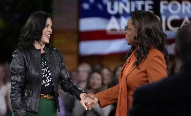 Michigan Gov. Gretchen Whitmer, left, joins Oprah Winfrey before the arrival of Democratic presidential nominee Vice President Kamala Harris at Oprah's Unite for America Live Streaming event Thursday, Sept. 19, 2024 in Farmington Hills, Mich. (AP Photo/Paul Sancya)