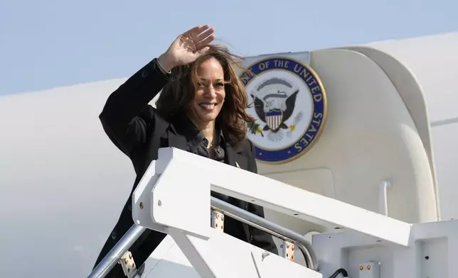 Democratic presidential nominee Vice President Kamala Harris waves to the media as she boards Air Force Two at John Murtha Johnstown-Cambria Airport, in Johnstown, Pa. Friday, Sept. 13, 2024. (AP Photo/Jacquelyn Martin)