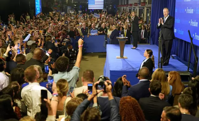 Democratic presidential nominee Vice President Kamala Harris speaks at a watch party as second gentleman Doug Emhoff, on stage at right, listens at Cherry Street Pier after the presidential debate in Philadelphia, Tuesday, Sept. 10, 2024. (AP Photo/Jacquelyn Martin)