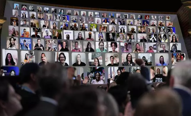 People watch via video ahead of the arrival of Democratic presidential nominee Vice President Kamala Harris who will join Oprah Winfrey at Oprah's Unite for America Live Streaming event Thursday, Sept. 19, 2024 in Farmington Hills, Mich. (AP Photo/Paul Sancya)