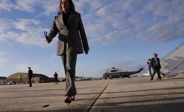 Democratic presidential nominee Vice President Kamala Harris walks over to speak to members of the media upon her arrival at Andrews Air Force Base, Md., Sunday, Sept. 22, 2024. (AP Photo/Matt Rourke/Pool)