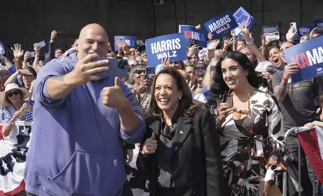 Democratic presidential nominee Vice President Kamala Harris takes a selfie with Sen. John Letterman, D-Pa., and his wife Gisele Barreto Fetterman, after Harris arrived at John Murtha Johnstown-Cambria Airport, in Johnstown, Pa., for a campaign event, Friday, Sept. 13, 2024. (AP Photo/Jacquelyn Martin)