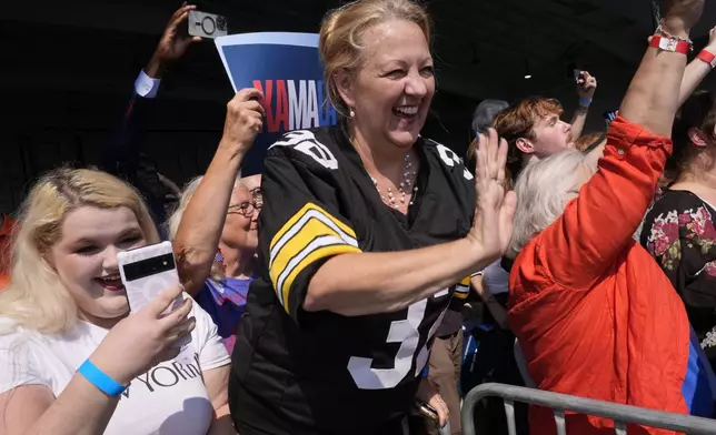 Supporters wave as Democratic presidential nominee Vice President Kamala Harris arrives at John Murtha Johnstown-Cambria Airport, in Johnstown, Pa., for a campaign event, Friday, Sept. 13, 2024. (AP Photo/Jacquelyn Martin)