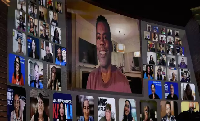 Chris Rock views via video Oprah Winfrey speak before Democratic presidential nominee Vice President Kamala Harris joins her at Oprah's Unite for America Live Streaming event Thursday, Sept. 19, 2024 in Farmington Hills, Mich. (AP Photo/Paul Sancya)