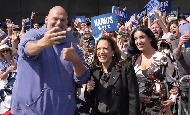 Democratic presidential nominee Vice President Kamala Harris takes a selfie with Sen. John Letterman, D-Pa., and his wife Gisele Barreto Fetterman, after Harris arrived at John Murtha Johnstown-Cambria Airport, in Johnstown, Pa., for a campaign event, Friday, Sept. 13, 2024. (AP Photo/Jacquelyn Martin)