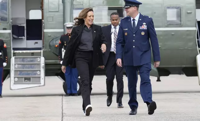 Democratic presidential nominee Vice President Kamala Harris, escorted by U.S. Air Force, Director of Flightline Protocol, Maj. Philippe Caraghiaur, walks to board Air Force Two, to travel to Pennsylvania for campaign events, Friday, Sept. 13, 2024, at Joint Base Andrews, Md. (AP Photo/Jacquelyn Martin)