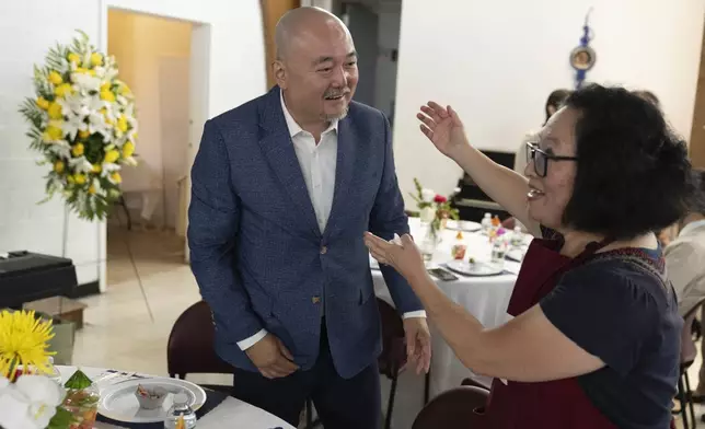 Dr. Soong-Chan Rah speaks wth a parishoner at the Korean Church of Boston, Saturday, Sept. 7, 2024, in Brookline, Mass. (AP Photo/Michael Dwyer)