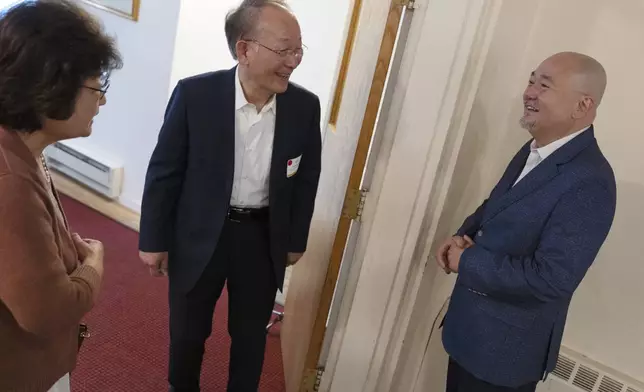 Dr. Soong-Chan Rah, right, speaks with Steve Hahn and his wife Kyung-Ae Kim Hahn at the Korean Church of Boston, Saturday, Sept. 7, 2024, in Brookline, Mass. (AP Photo/Michael Dwyer)