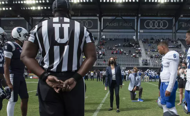 Vice President Kamala Harris takes part in the ceremonial coin toss before an NCAA college football game between Howard and Hampton in Washington, Sept. 18, 2021. (AP Photo/Cliff Owen, File)