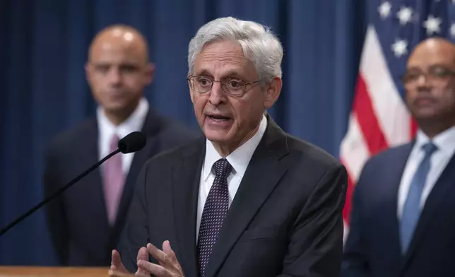 Attorney General Merrick Garland, flanked by Matt Graves, U.S. attorney for the District of Columbia, left, and Ronald Davis, director of the United States Marshals Service, holds a news conference as the Justice Department announced criminal charges against Iranian operatives suspected of hacking Donald Trump's presidential campaign and disseminating stolen information to media organizations, at the Justice Department in Washington, Friday, Sept. 27, 2024. (AP Photo/J. Scott Applewhite)