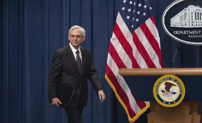 Attorney General Merrick Garland arrives for a news conference as the Justice Department announced criminal charges against Iranian operatives suspected of hacking Donald Trump's presidential campaign and disseminating stolen information to media organizations, at the Justice Department in Washington, Friday, Sept. 27, 2024. (AP Photo/J. Scott Applewhite)