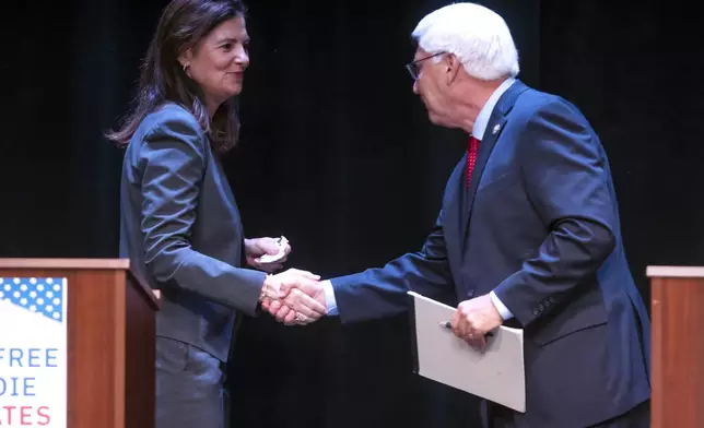 Republican gubernatorial candidates Kelly Ayotte and Chuck Morse shake hands at the end of their debate at the Rosamond Page Putnam Center for the Performing Arts on the campus of New England College in Henniker, N.H., Wednesday night, Sept. 4, 2024. (Geoff Forester/The Concord Monitor via AP)