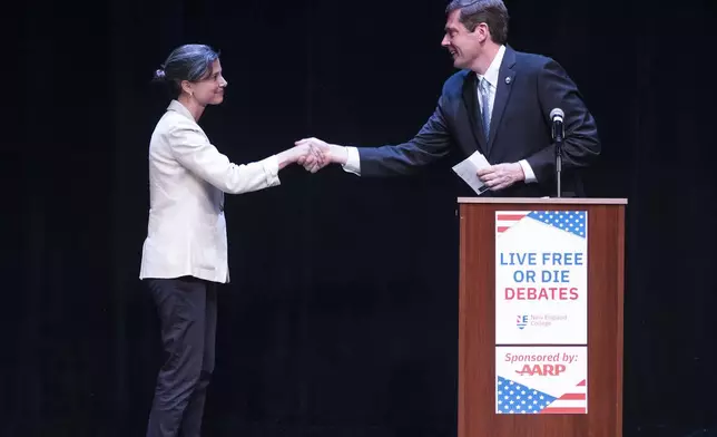 Democratic congressional candidates Maggie Goodlander, left, and Colin Van Ostern shake hands after the Live Free or Die Debates at the Rosamond Page Putnam Center for the Performing Arts on the campus of New England College in Henniker, N.H., Wednesday evening, Sept. 4, 2024. The candidates are hoping to replace U.S. Rep. Annie Kuster who is not running for reelection. (Geoff Forester/The Concord Monitor via AP)