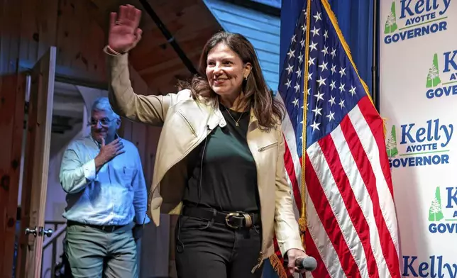 Republican gubernatorial candidate Kelly Ayotte waves to the crowd at Bonfire Country Bar in Manchester, N.H., after winning the Republican primary against former state Senate President Chuck Morse on Tuesday, Sept. 10, 2024. (Geoff Forester/The Concord Monitor via AP)