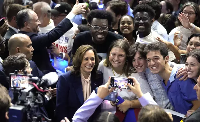 FILE - Democratic presidential nominee Vice President Kamala Harris poses for a photo with supporters at a campaign rally in Philadelphia, Aug. 6, 2024. (AP Photo/Matt Rourke, File)